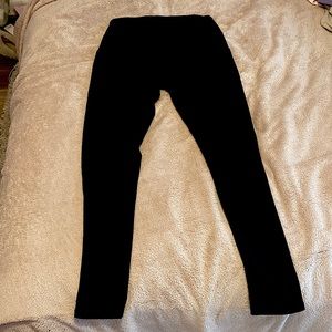 Black leggings, ankle length.